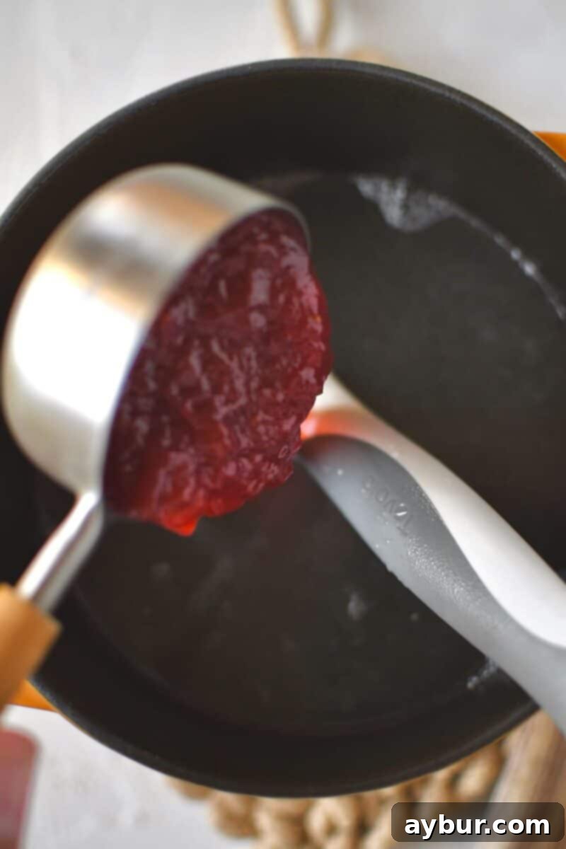 Sweet Strawberry Lemonade 4 Step-by-step process of making strawberry lemonade, showing ingredients and mixing.