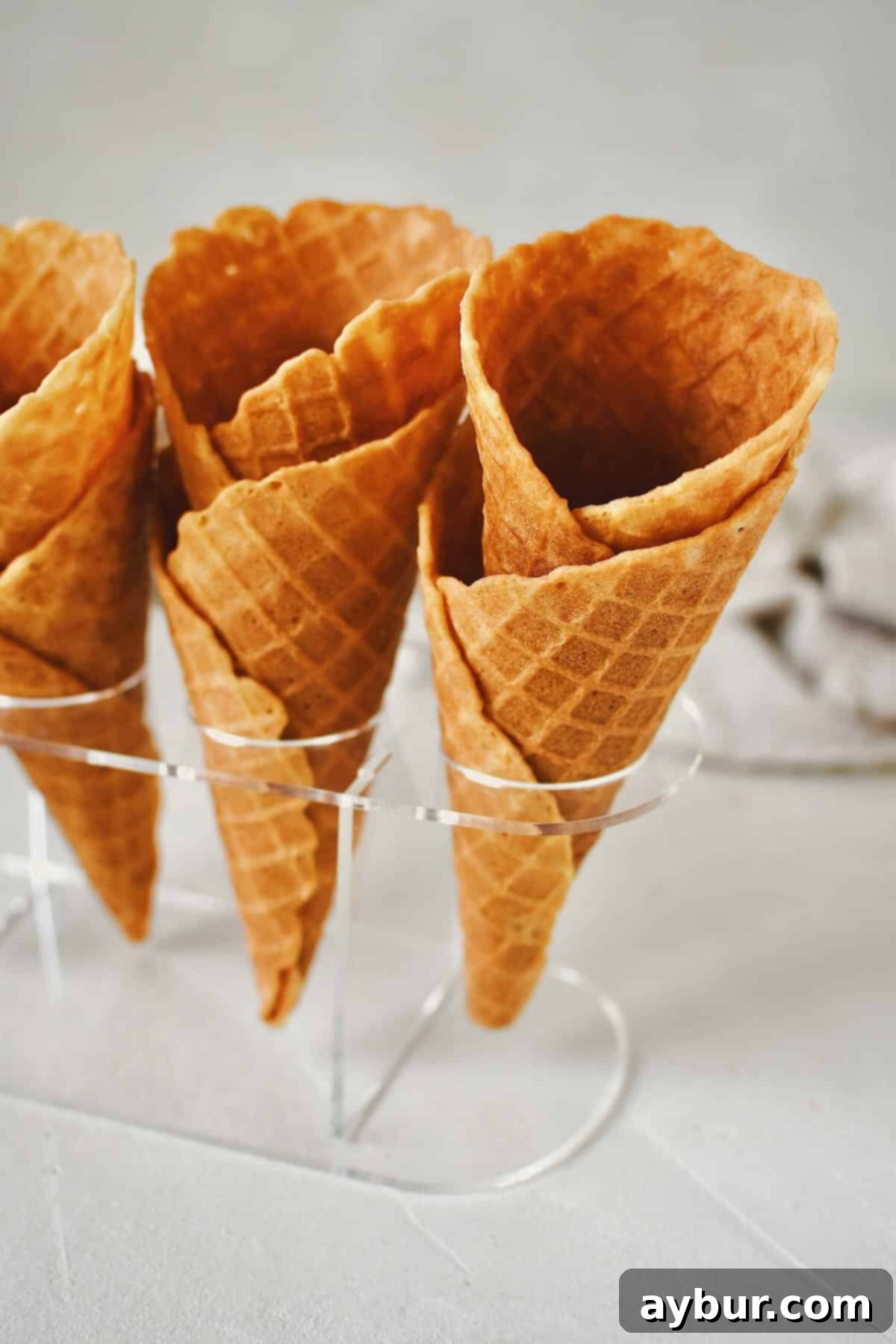 Crispy Homemade Waffle Cones 2 Finished Waffle Cone Recipe resting in a stand and ready to be filled with ice cream.
