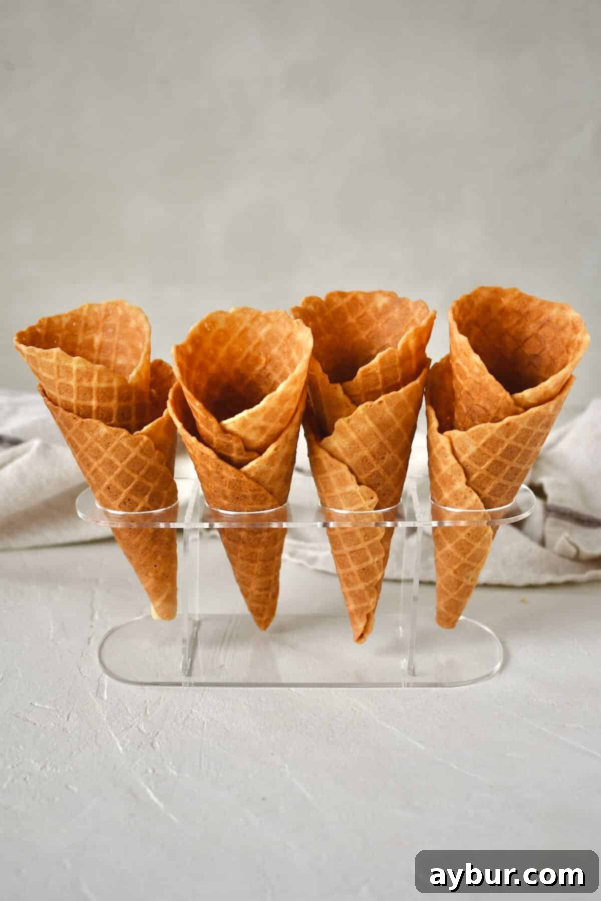 Crispy Homemade Waffle Cones 14 Finished Waffle Cone Recipe resting in a stand and ready to be filled with ice cream.