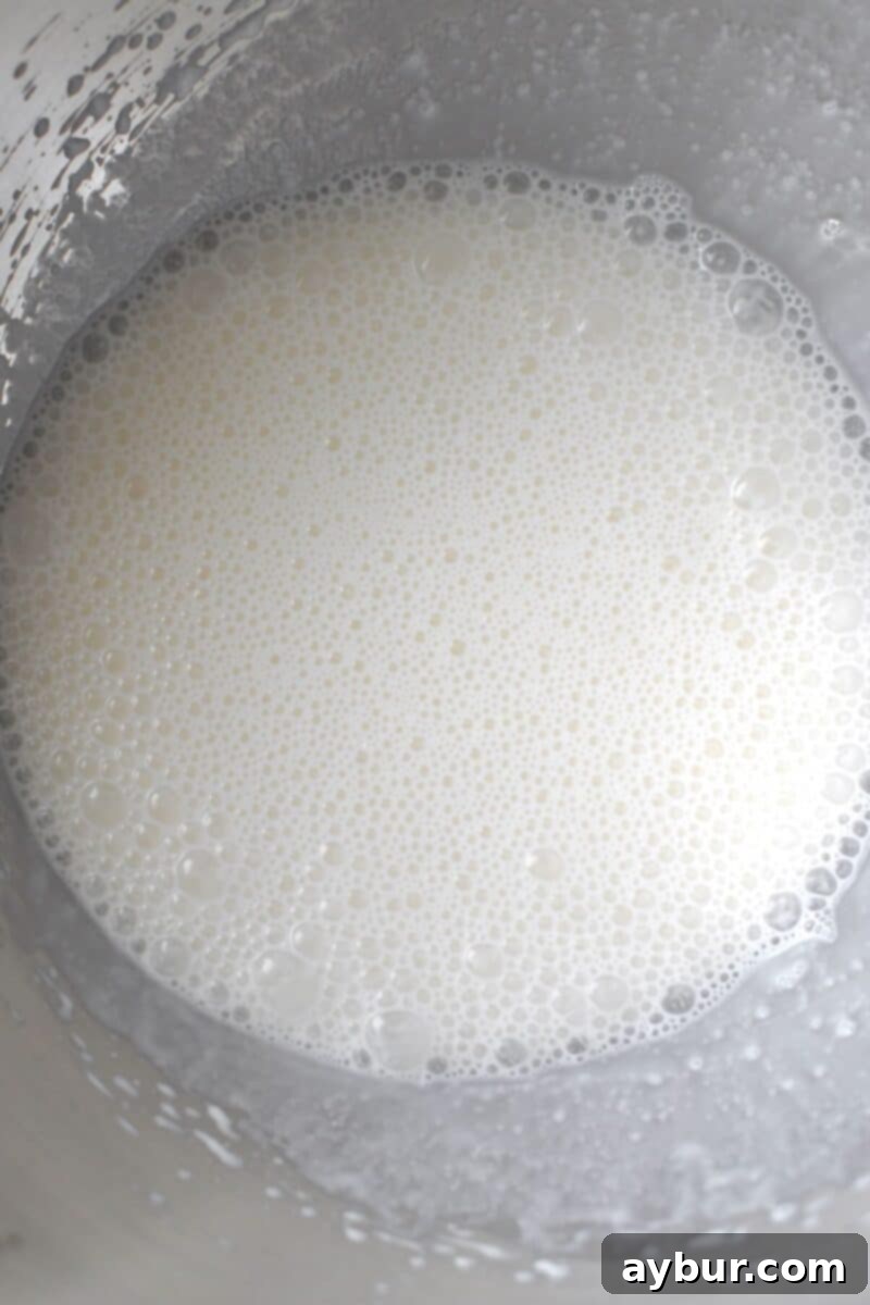 Crispy Homemade Waffle Cones 4 Cream and Egg Whites whipped together in a stand mixer bowl.