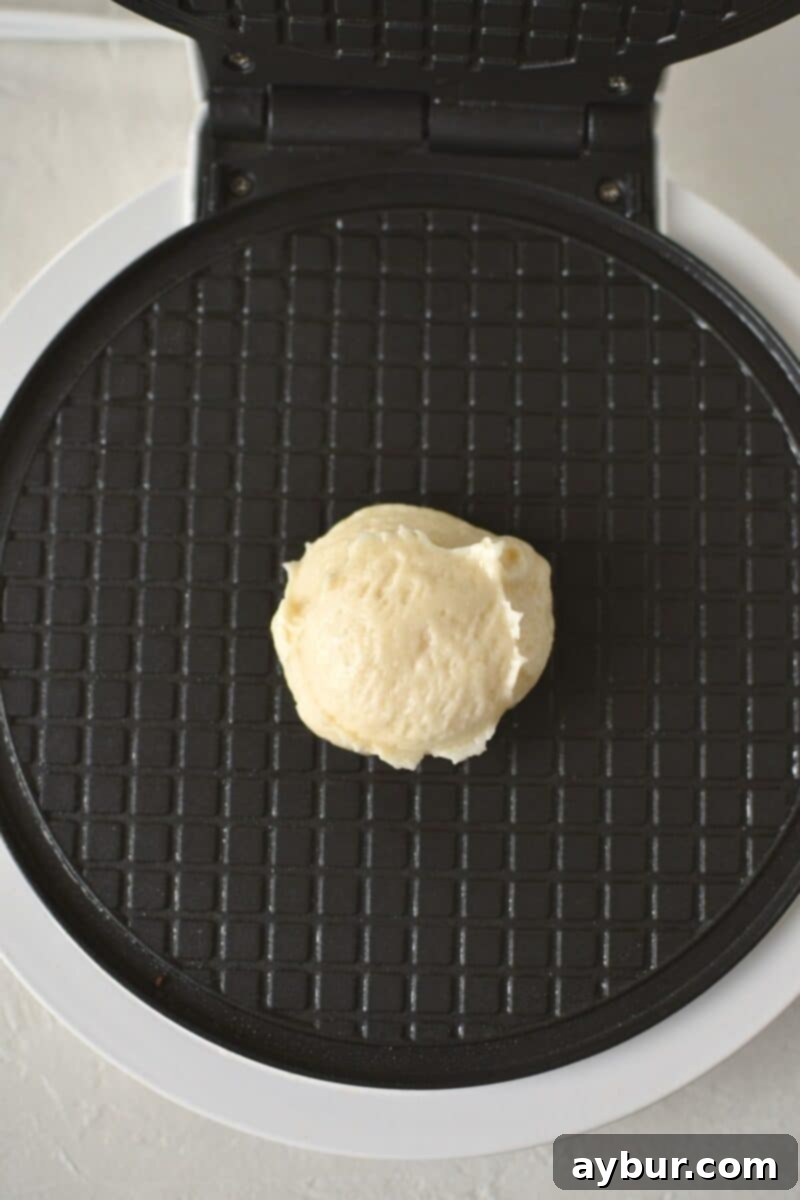 Crispy Homemade Waffle Cones 8 A scoop of waffle cone batter on a iron, before cooking.