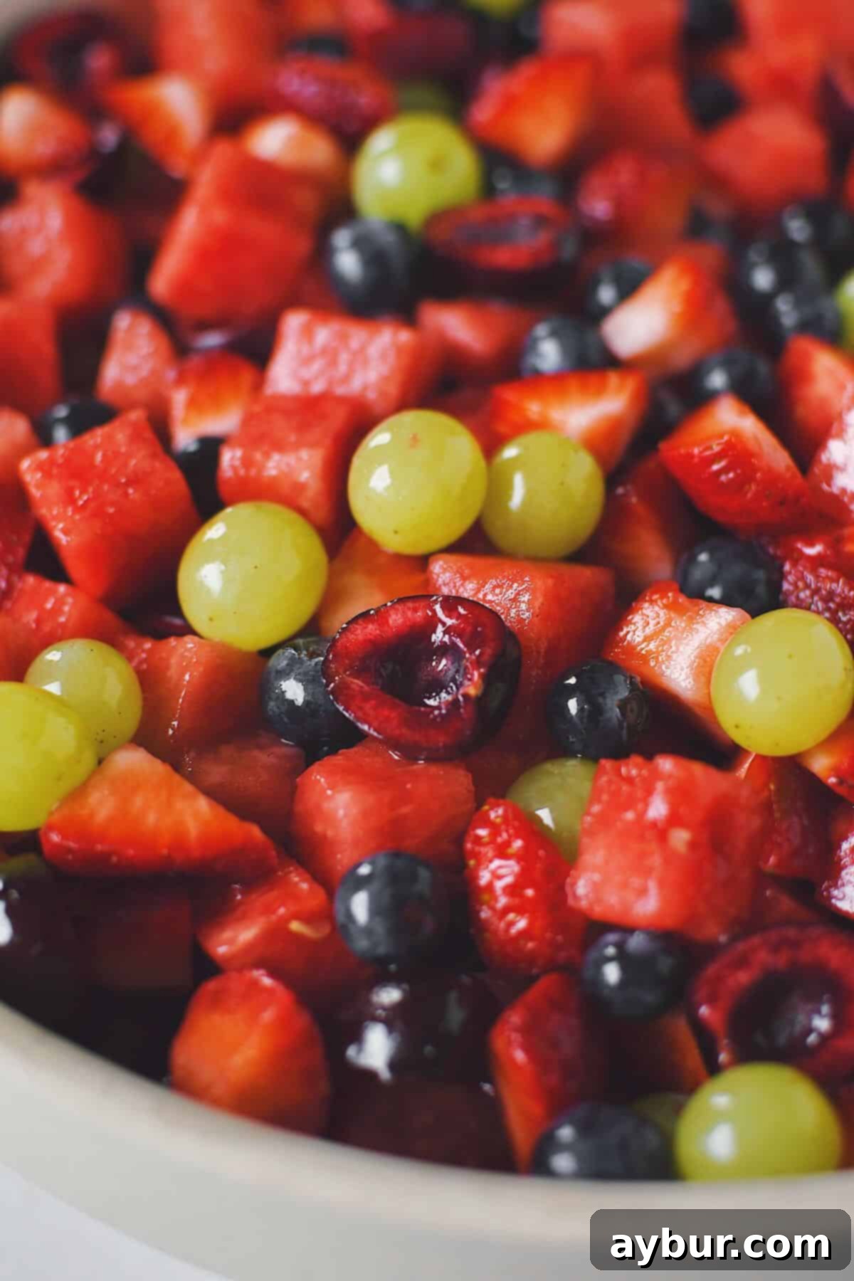 A vibrant and refreshing Summer Fruit Salad, perfectly tossed and ready to be served, showcasing an array of fresh seasonal fruits.