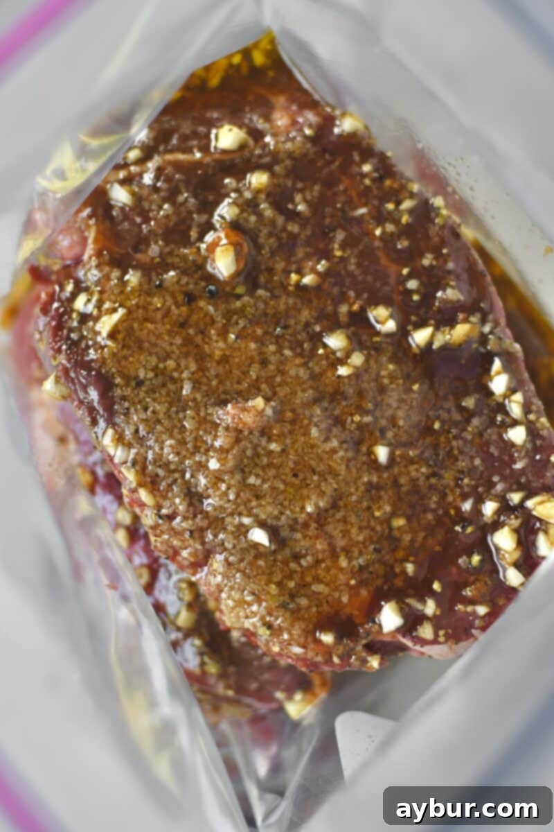 Adding the marinade to a bag with the steak, showing the liquid being poured over the meat.