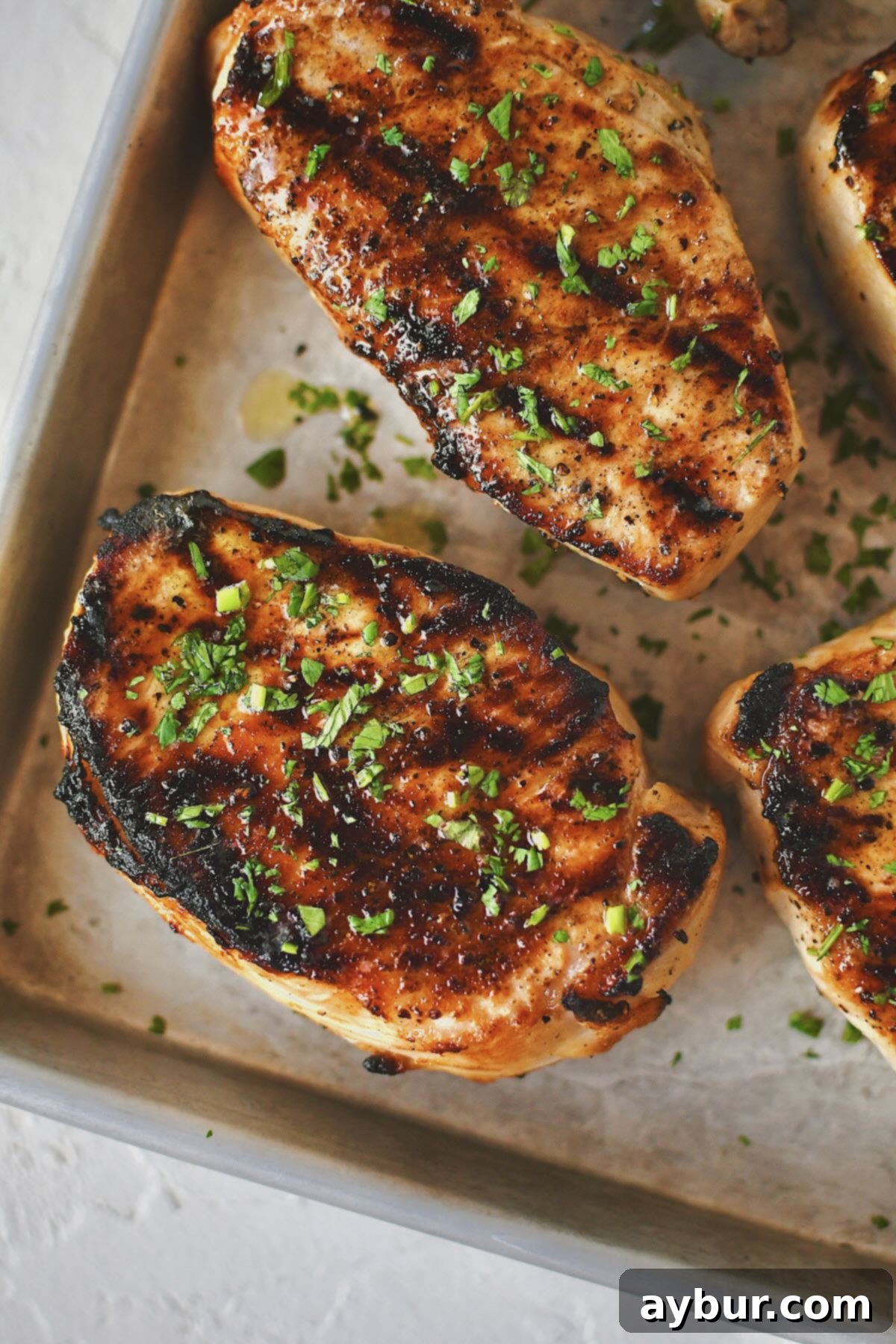 Succulent Brined Pork Chops, fresh off the grill, displaying a perfect sear and ready to be enjoyed.