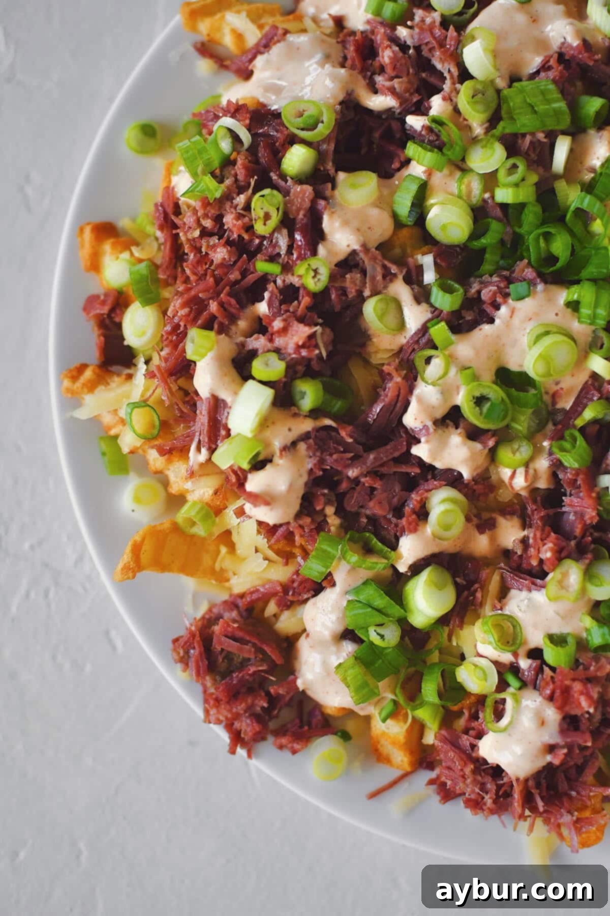 Irish Nachos 10 Finished Irish Nachos with white cheddar, corned beef, remoulade, and green onions on top of crispy crinkle french fries.