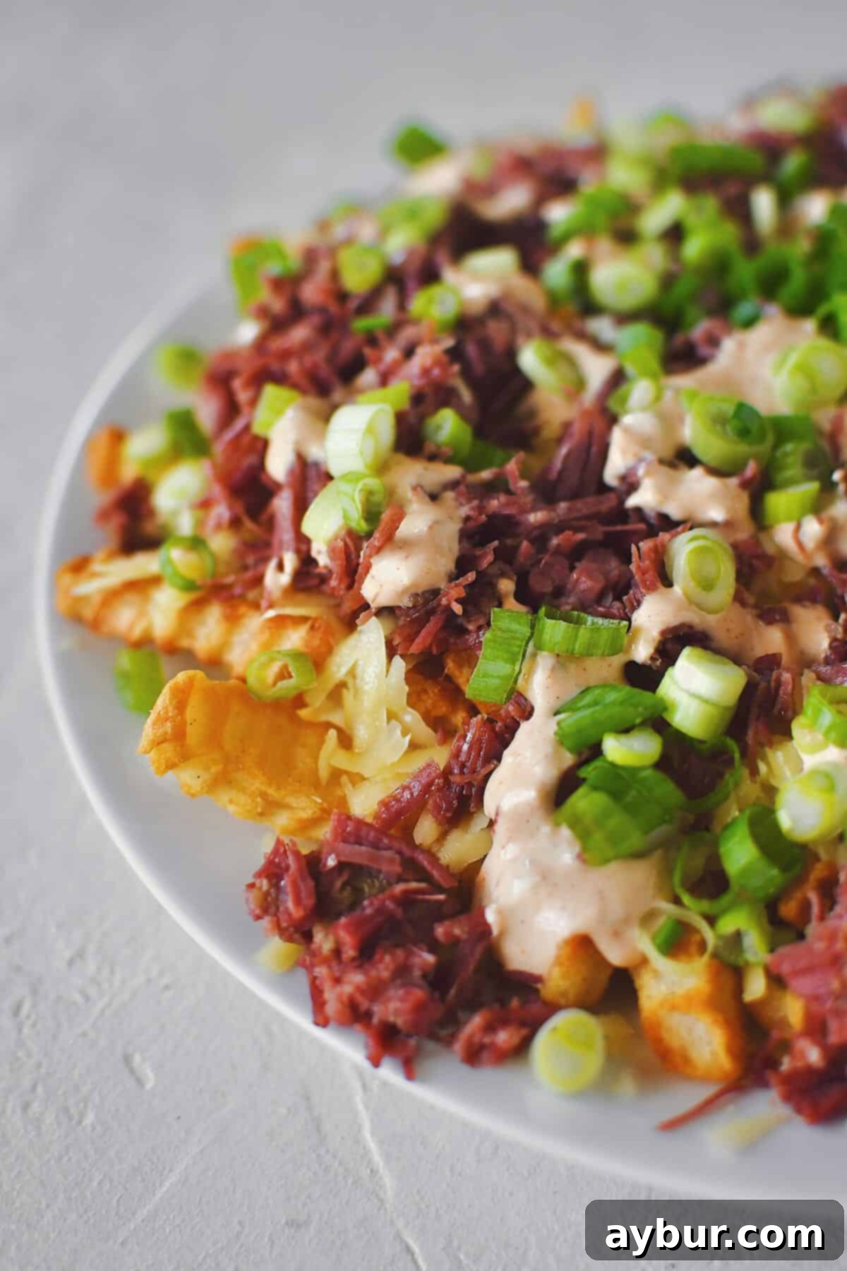 Irish Nachos 7 Finished Irish Nachos with white cheddar, corned beef, remoulade, and green onions on top of crispy crinkle french fries.