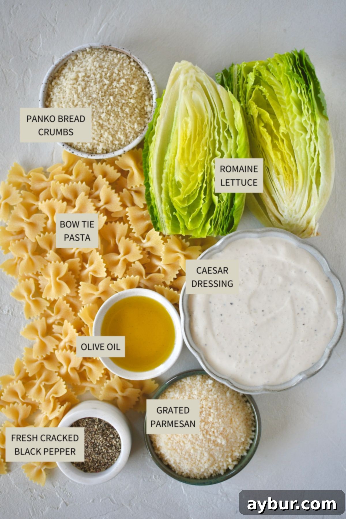 Savory Caesar Pasta Feast 3 Ingredients needed to make Caesar Pasta Salad, including pasta, romaine, parmesan, panko, and dressing.