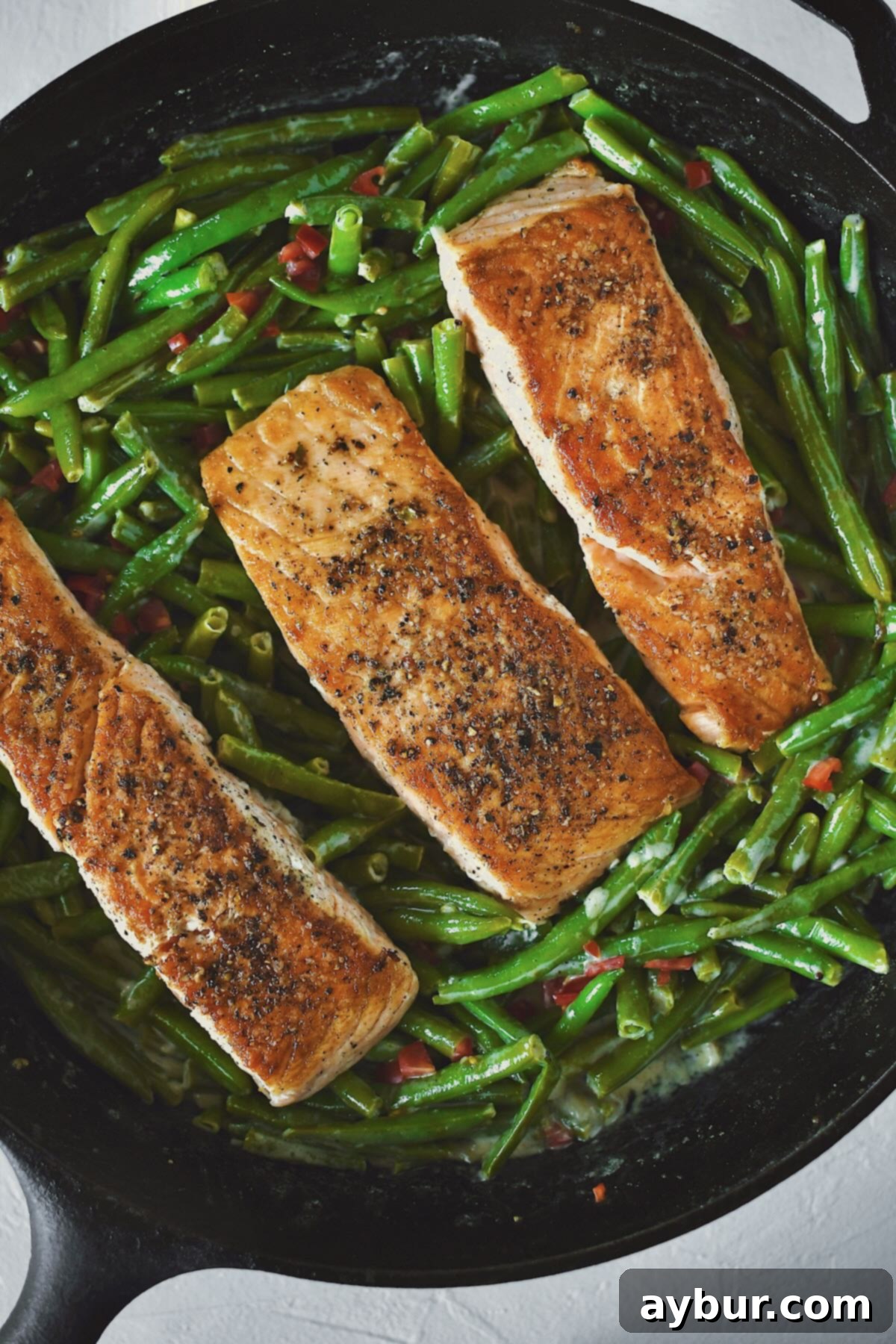 Pan Seared Salmon fillets nestled into some sauteed green beans.