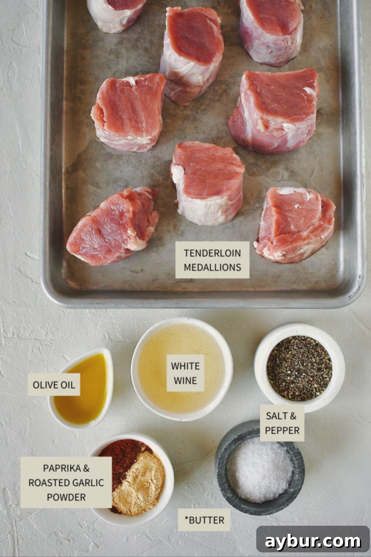 All the necessary ingredients laid out for preparing Pork Tenderloin Medallions, including pork, spices, and liquids.