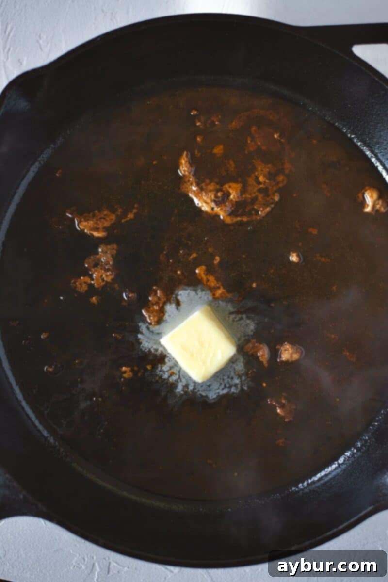 Pork medallions removed from the pan, with white wine and butter added to deglaze and create a pan sauce.