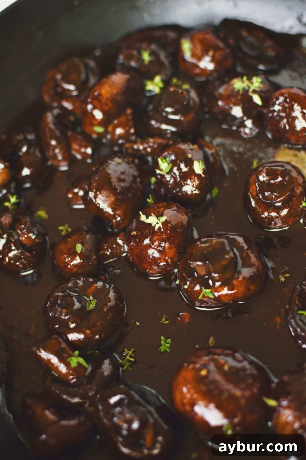 The finished Steakhouse Mushrooms, beautifully coated in a thick, dark demi-glace sauce, ready to be served as a luxurious side.