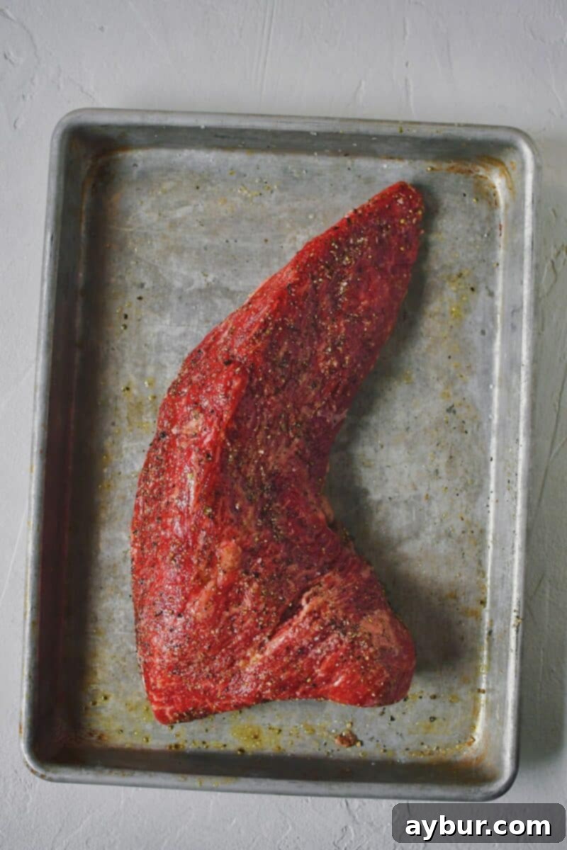 Perfect Tri-Tip Every Time 4 Tri-Tip seasoned with salt, pepper, and olive oil, resting before cooking to allow flavors to penetrate.