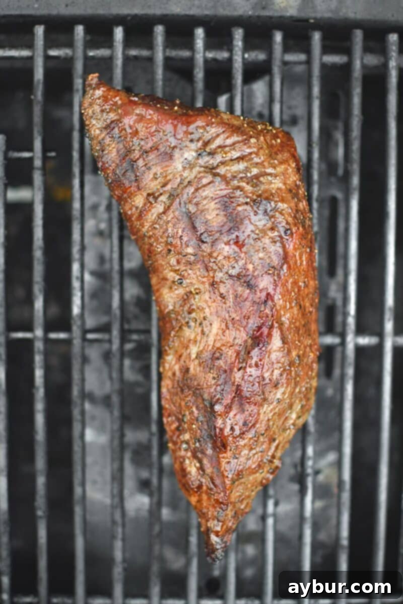Perfect Tri-Tip Every Time 5 Tri-Tip placed on a hot grill, searing the second side.