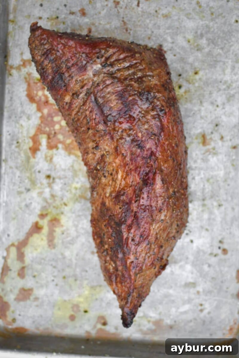 Perfect Tri-Tip Every Time 6 Cooked Tri-Tip resting on a cutting board, ready to be sliced after grilling.