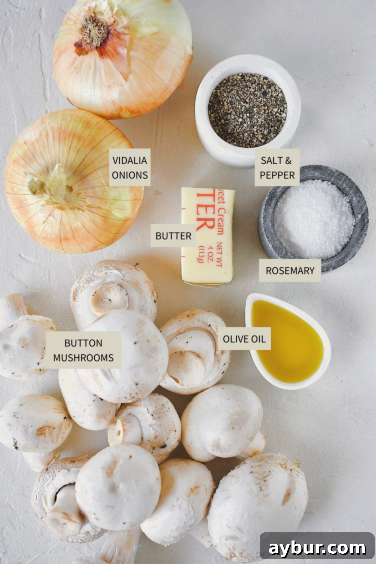 Caramelized Mushrooms and Onions 3 Fresh ingredients laid out: Button mushrooms, sliced Vidalia onions, unsalted butter, and extra virgin olive oil for preparing sautéed mushrooms and onions.