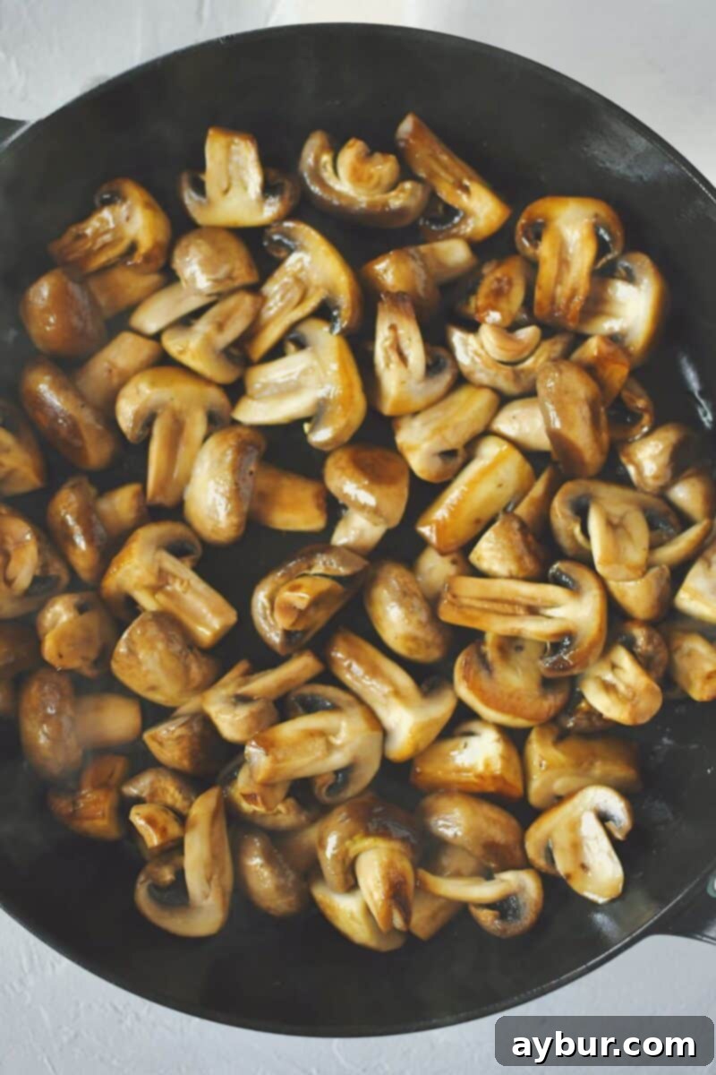 Caramelized Mushrooms and Onions 5 Mushrooms after steaming for 5 minutes, showing the liquid released in the pan.