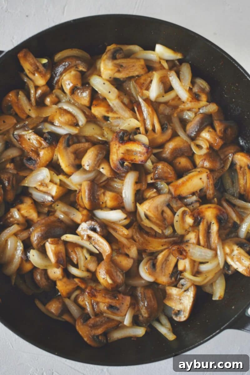 Caramelized Mushrooms and Onions 7 Sautéed mushrooms and onions, tender and golden brown, fully cooked in the skillet, glistening with butter.