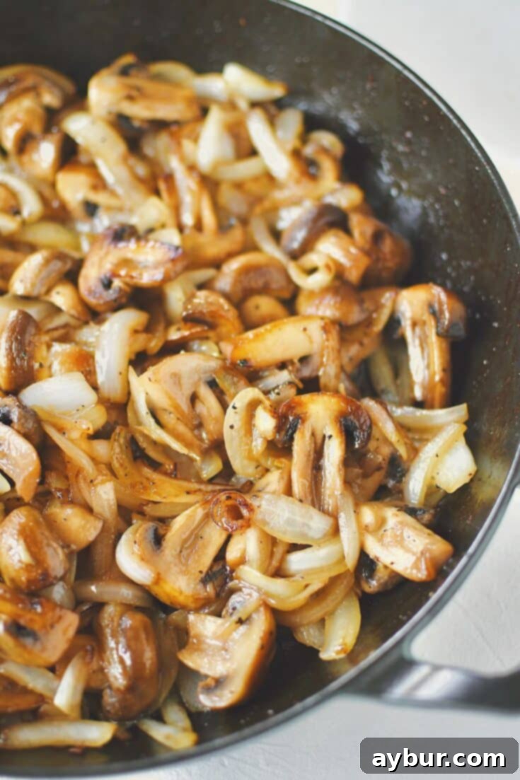 Caramelized Mushrooms and Onions 10 Sautéed Mushrooms and Onions, finished in the skillet, ready to be eaten.