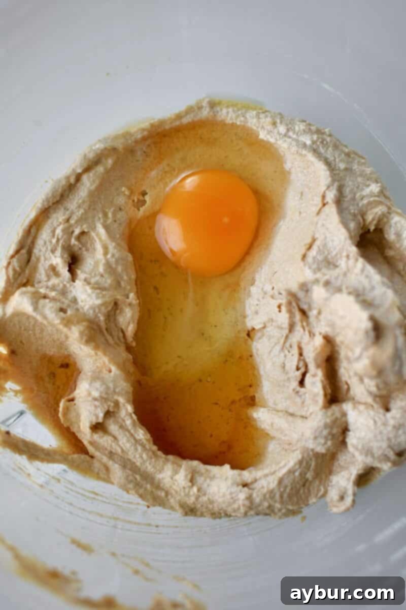 Gooey Chocolate Marshmallow Cookies 5 Adding the egg and vanilla to the creamed butters and sugars.