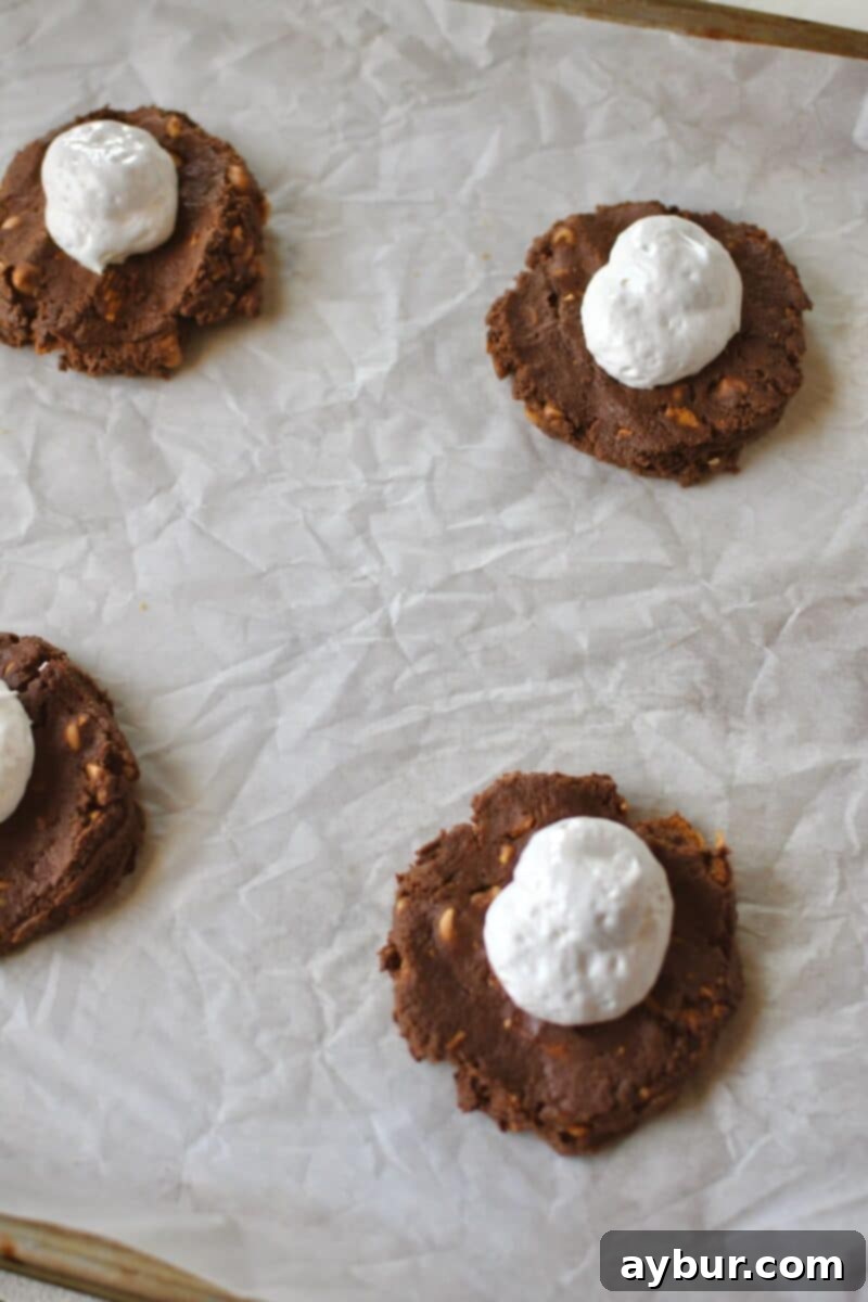 Gooey Chocolate Marshmallow Cookies 9 Piping marshmallow cream onto the center of flattened cookie dough.
