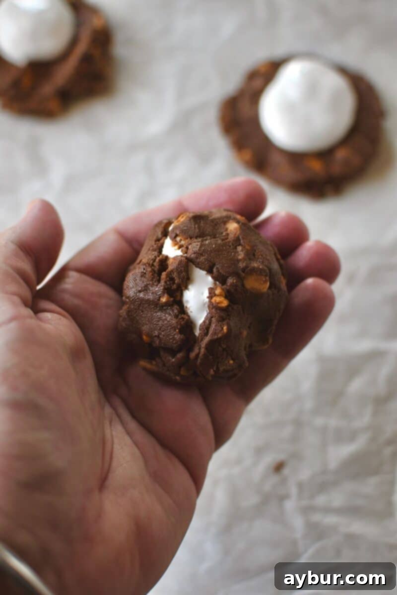 Gooey Chocolate Marshmallow Cookies 10 Folding cookie dough around marshmallow cream to seal it inside.
