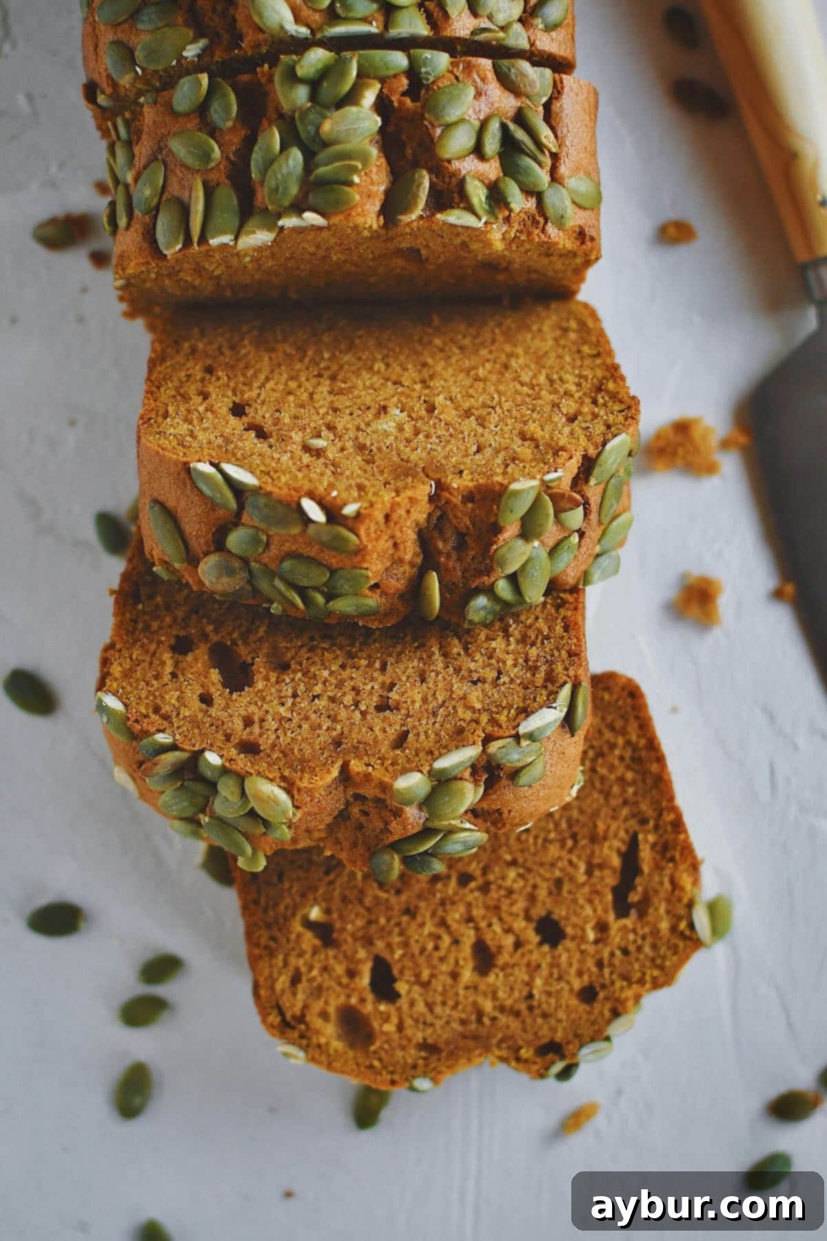 Perfectly sliced homemade Pumpkin Spice Bread, ready to be enjoyed with a cup of coffee or tea.