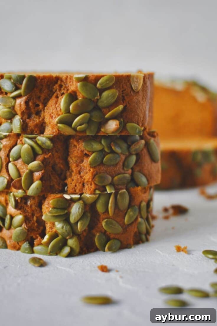 Perfectly sliced homemade Pumpkin Spice Bread, ready to be enjoyed with a cup of coffee or tea.