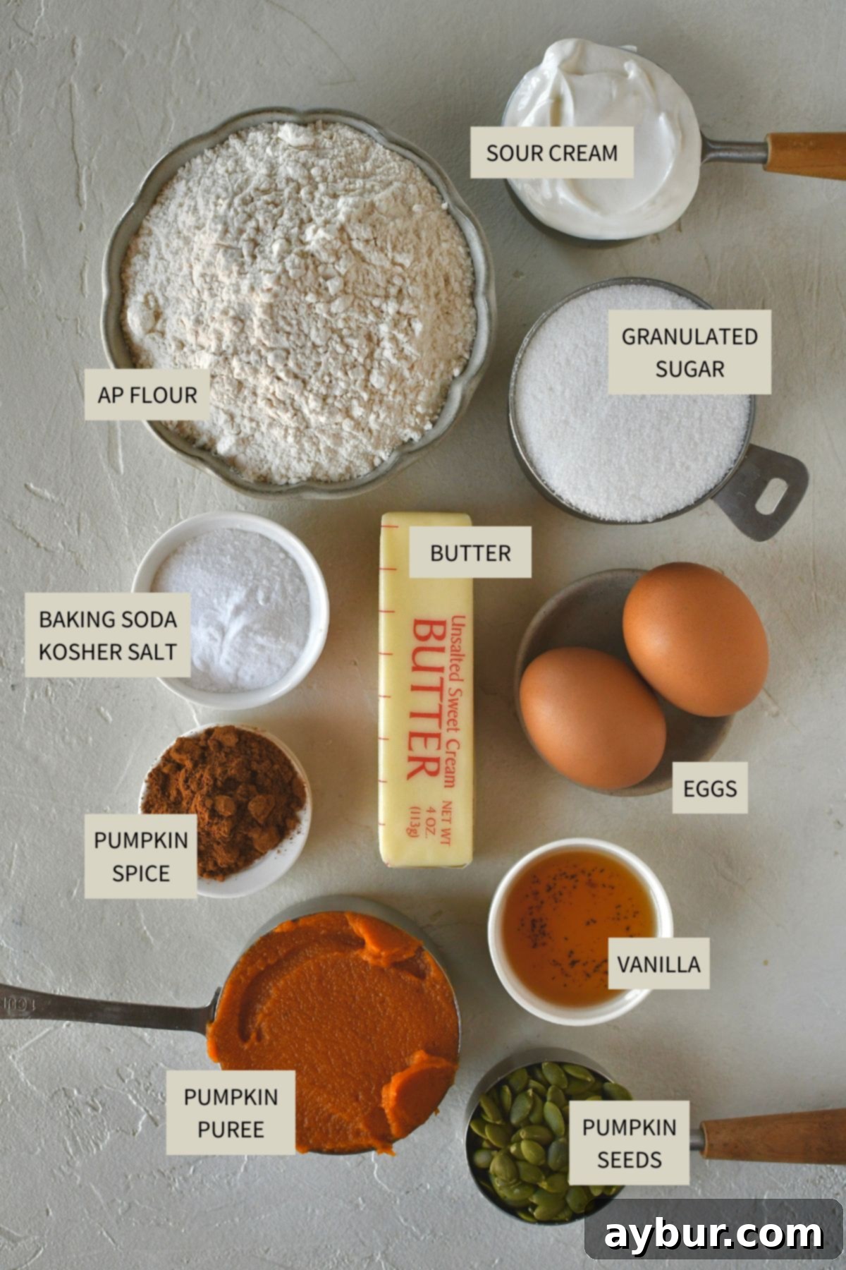 All the essential ingredients neatly laid out on a kitchen counter, ready to be combined for Pumpkin Spice Bread.