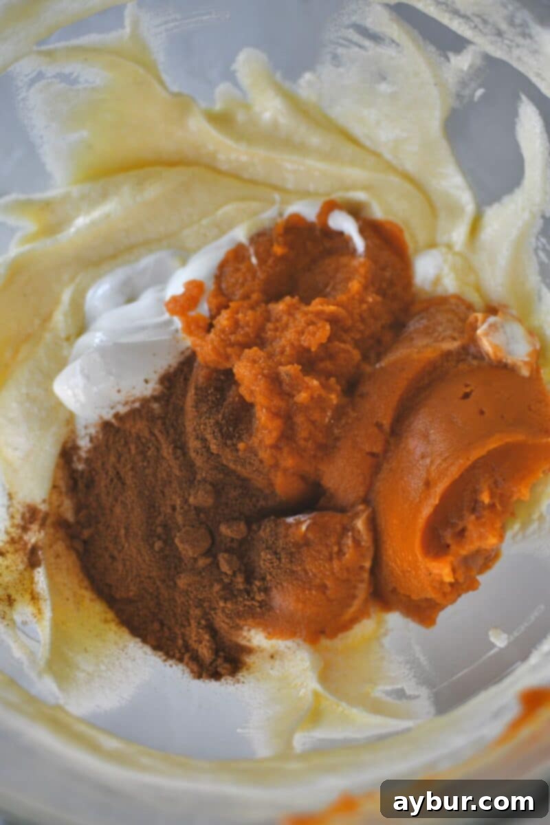 Incorporating sour cream, pumpkin puree, and pumpkin spice blend into the wet ingredients for a rich flavor.