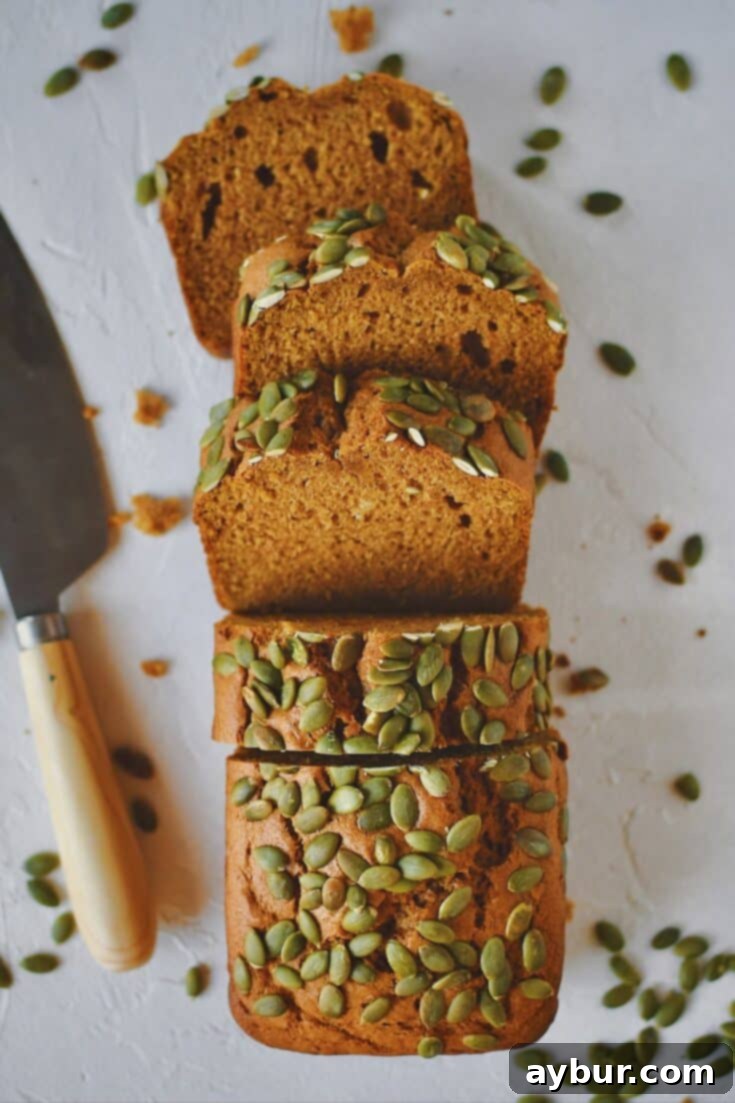 Perfectly sliced homemade Pumpkin Spice Bread, ready to be enjoyed with a cup of coffee or tea.