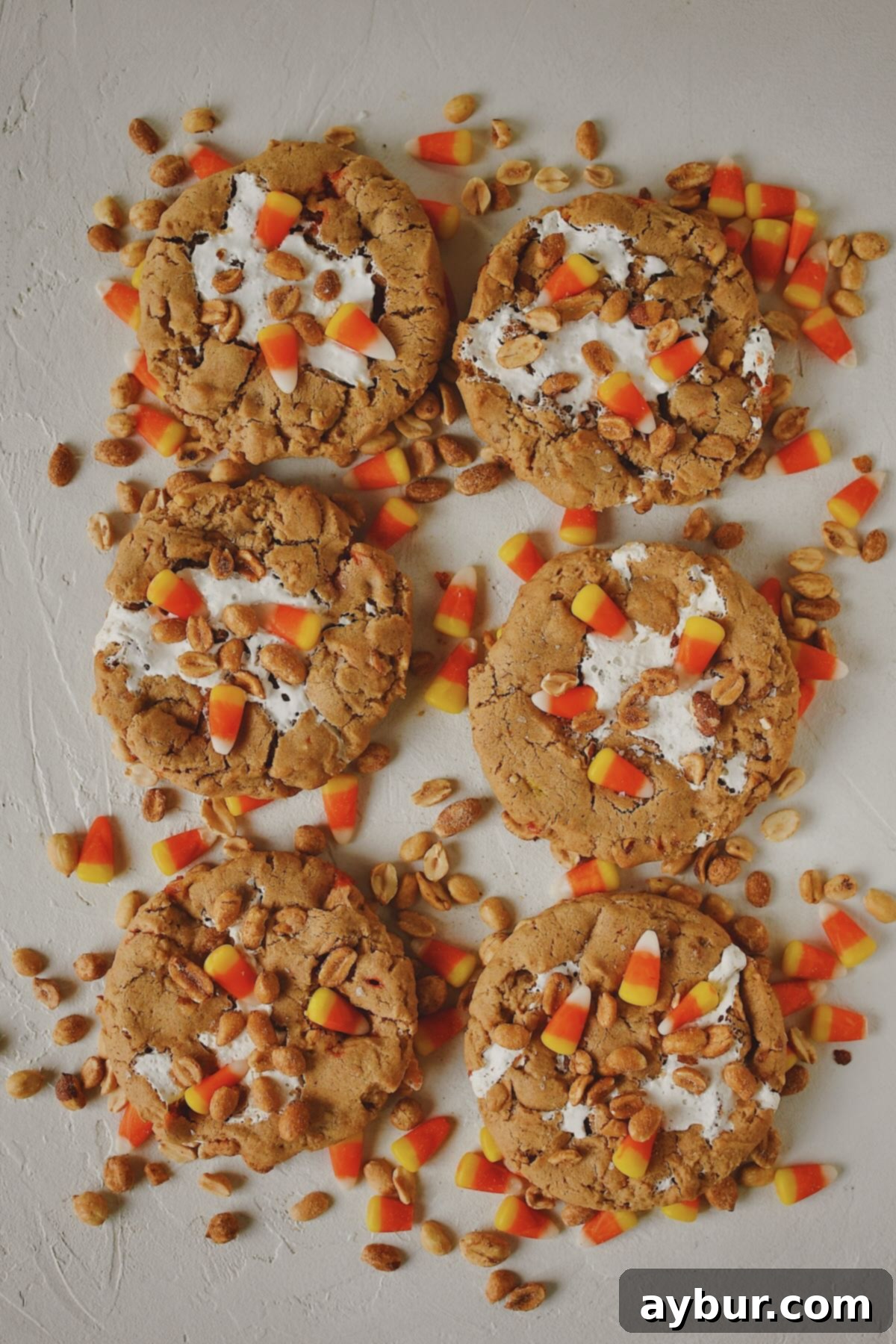 Spooky Sweet Candy Corn Cookies 11 Finished Candy Corn Cookies laid out on a table with candy corn and peanuts snack mix under them, ready to eat!