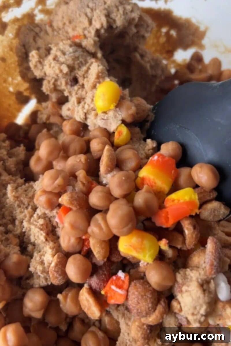 Spooky Sweet Candy Corn Cookies 8 Folding in some candy corn, caramel bits, and honey roasted peanuts.