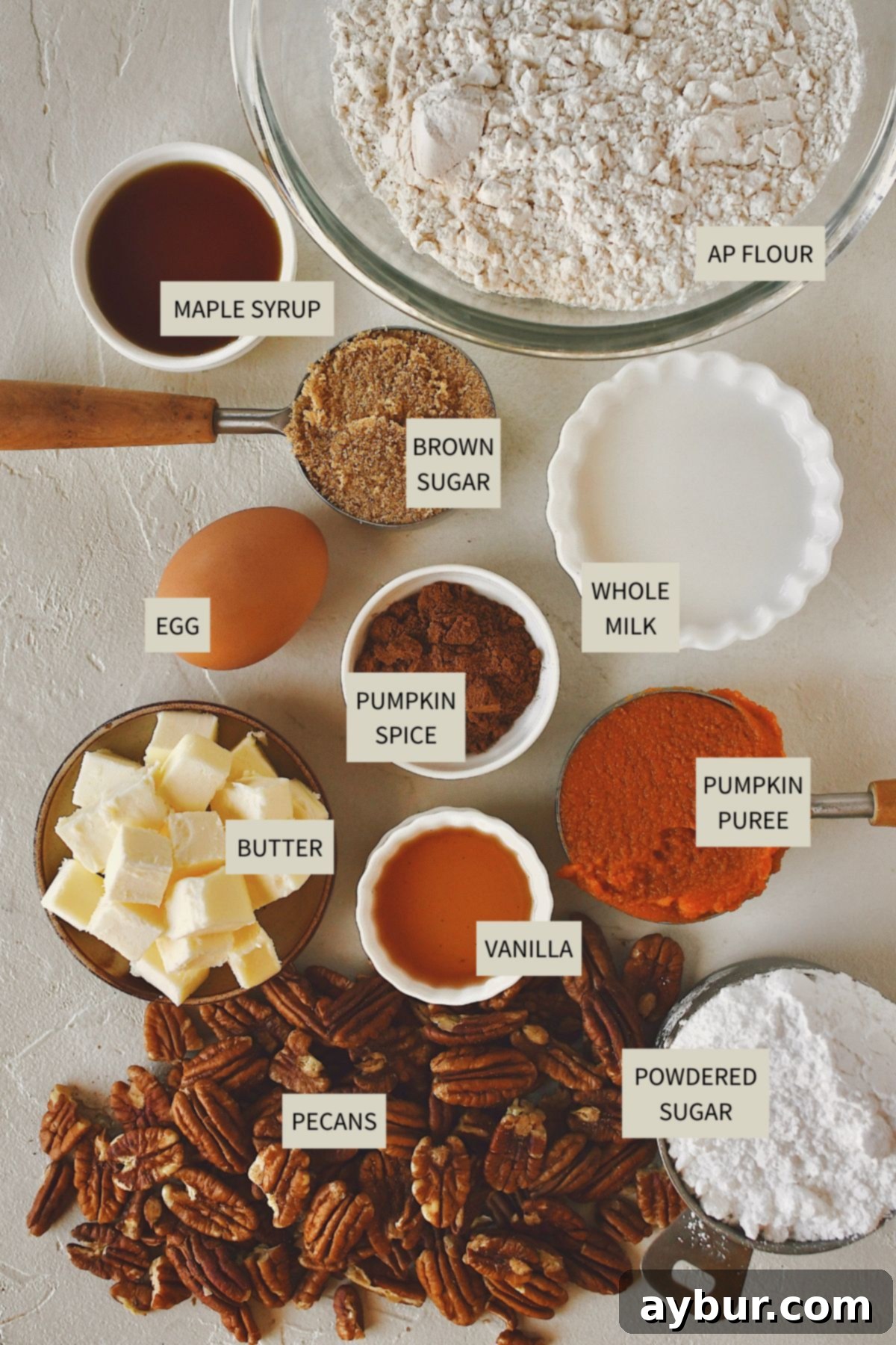 A vibrant display of fresh ingredients laid out, including flour, brown sugar, butter, pumpkin puree, spices, and pecans, all ready to be transformed into delicious Pumpkin Scones.