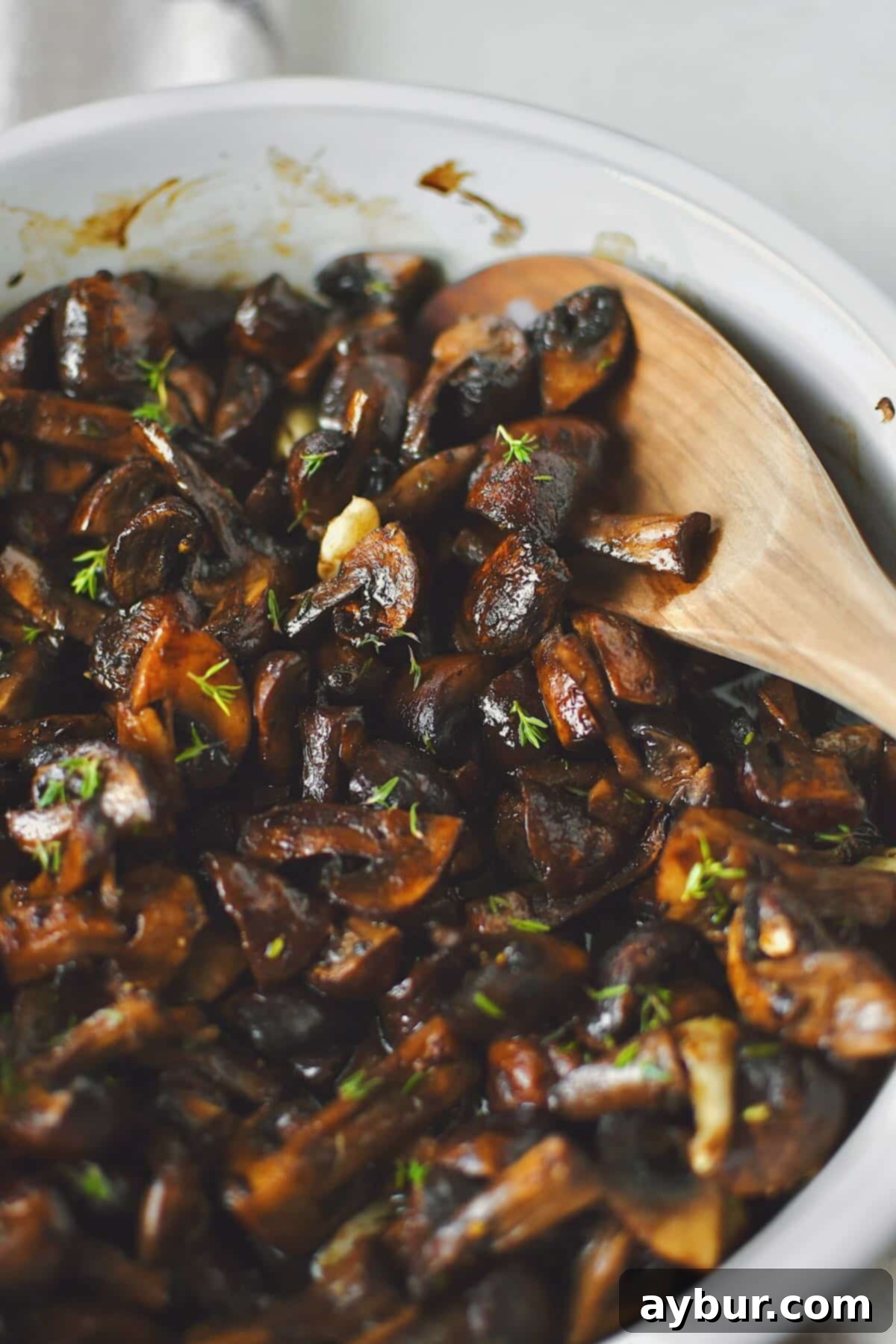 Earthy Roasted Delights 2 Roasted Mushrooms after roasting and tossing with aged balsamic vinegar, garnished with fresh thyme.