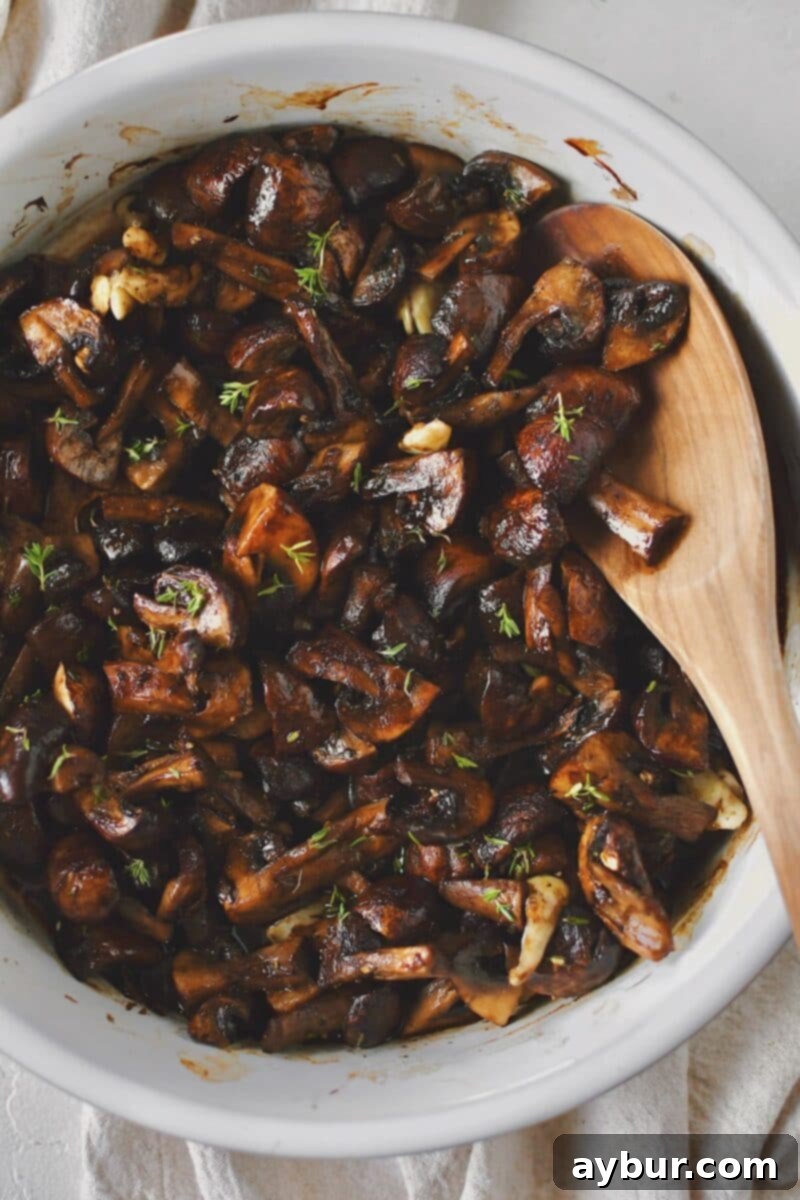 Earthy Roasted Delights 5 Roasted crimini mushrooms, golden brown and tender, after roasting with olive oil, garlic, and thyme.