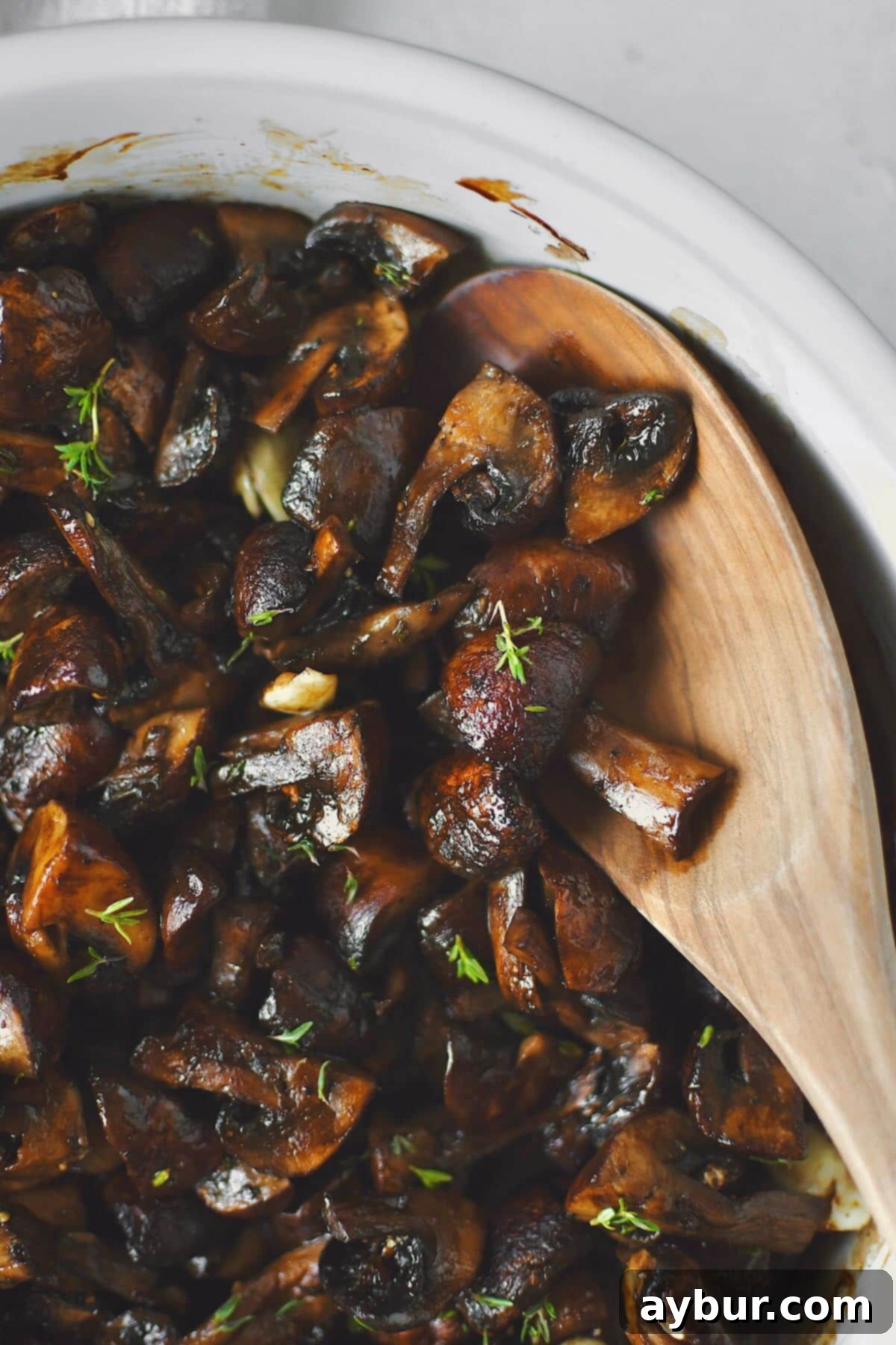 Earthy Roasted Delights 7 Serving of roasted mushrooms in a rustic bowl, garnished with fresh herbs.