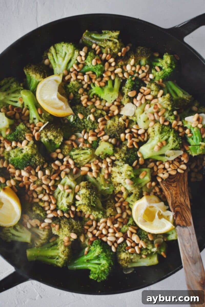 Sautéed Broccoli 7 Sautéed broccoli finished with toasted pine nuts and lemon wedges, ready to be served.