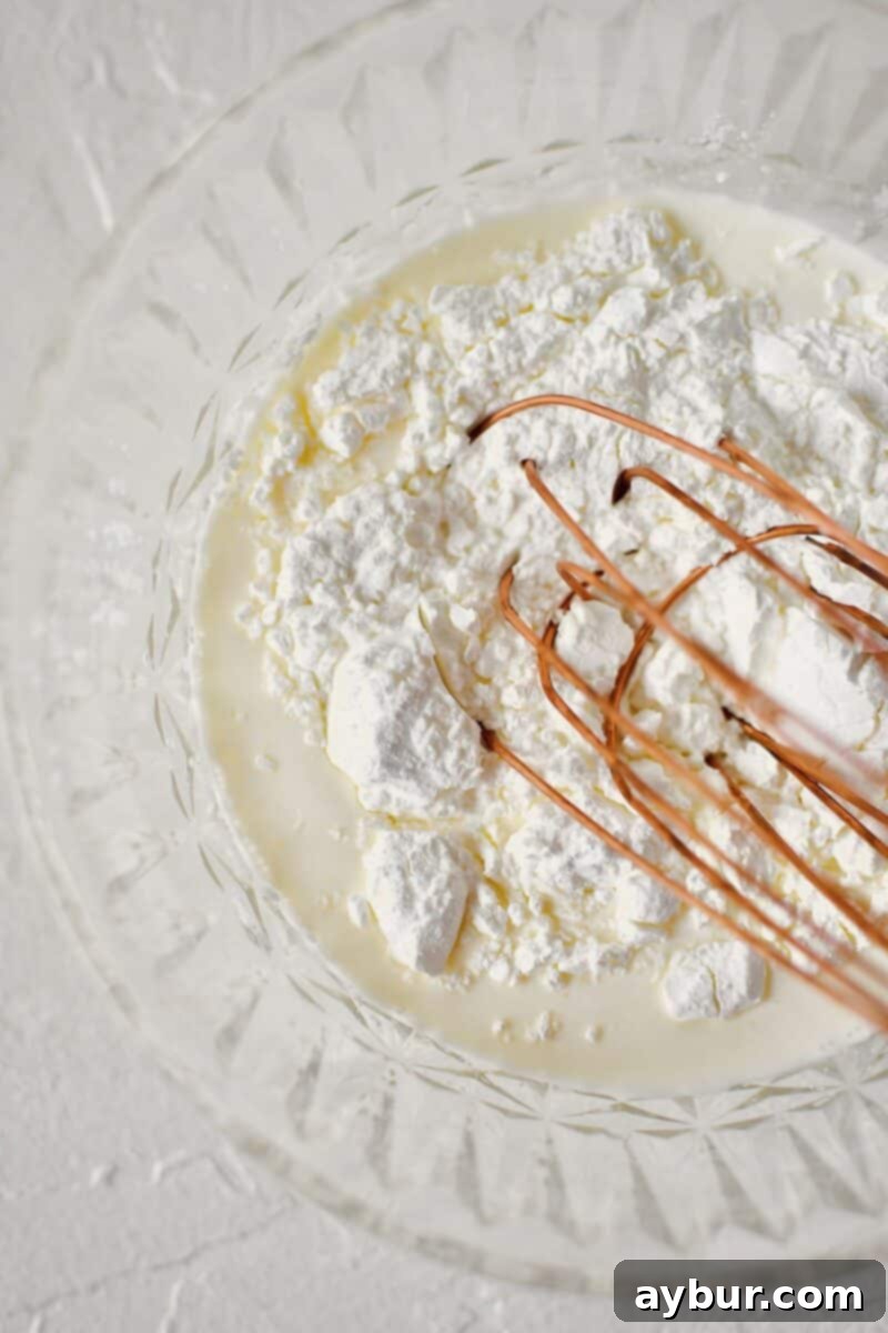 Sweet Peach Dream 4 Whisking together some heavy cream and cornstarch to make a smooth slurry, an essential step for thickening the ice cream base.