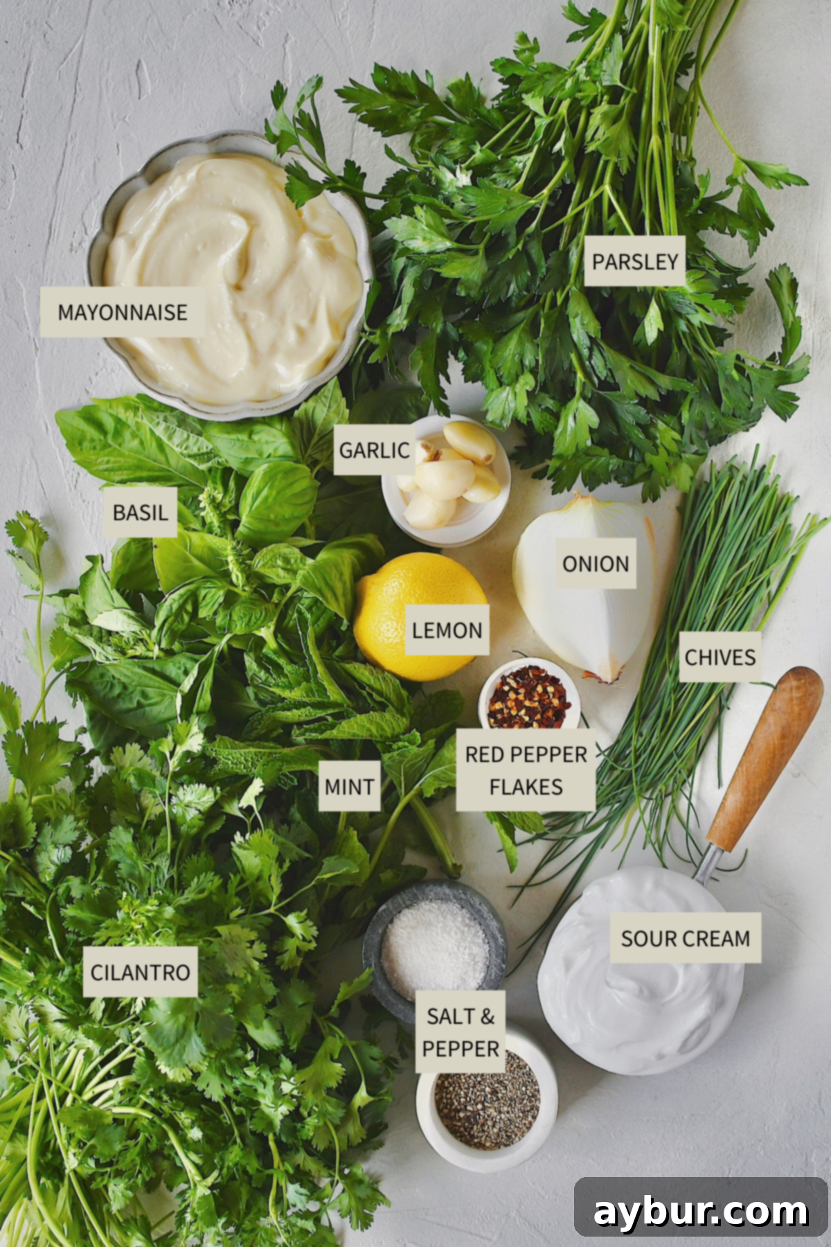 Fresh ingredients laid out on a wooden board, ready to be prepared for the Green Goddess Dressing Recipe.