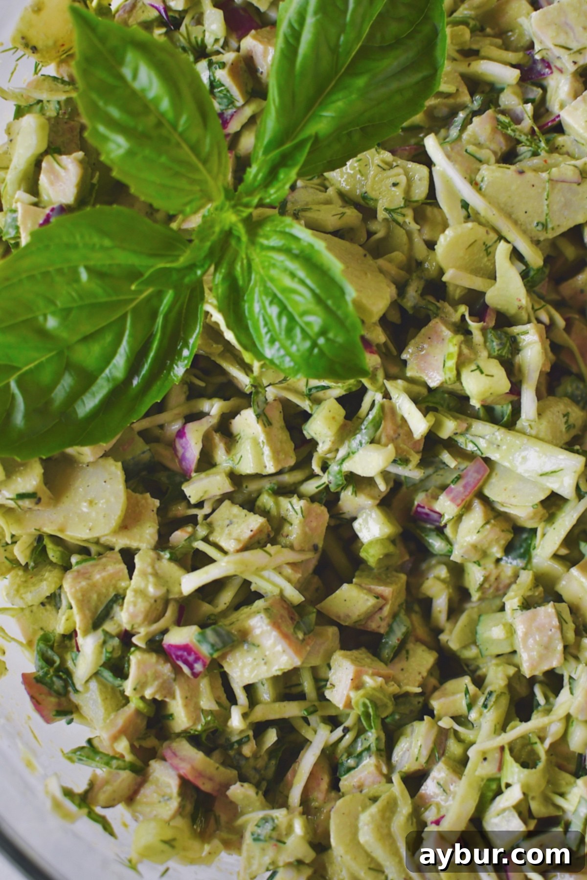 Emerald Goddess Chicken Salad 2 Fully mixed Green Goddess Chicken Salad in a large bowl, ready to be enjoyed.