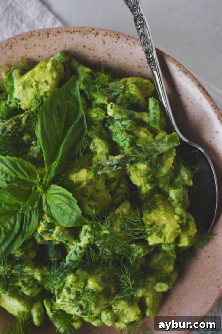 Vibrant Green Goddess Potato Salad 11 Finished Green Goddess Potato Salad ready to be served from a large serving bowl, with fresh herbs.