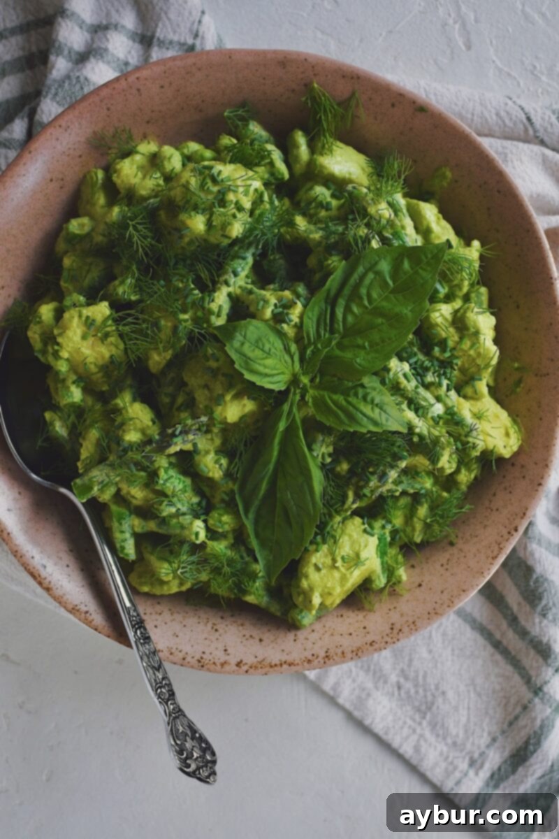 Vibrant Green Goddess Potato Salad 9 Green Goddess Potato Salad served in an elegant bowl on a rustic wooden table, garnished with fresh herbs.