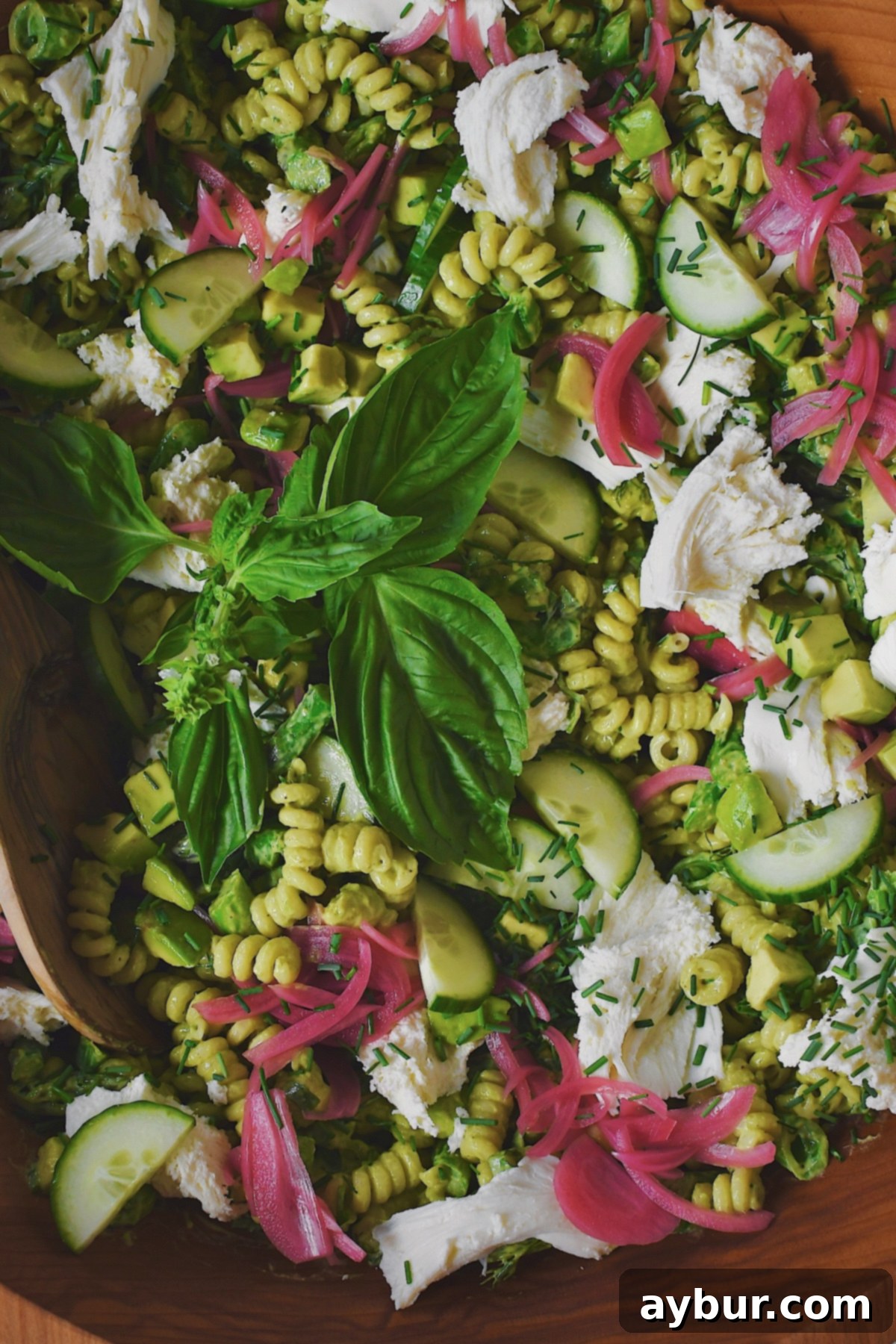 Vibrant Green Goddess Pasta 2 Topping the Green Goddess Pasta Salad before serving with torn fresh mozzarella, vibrant pickled red onions, and a sprinkle of reserved chives.