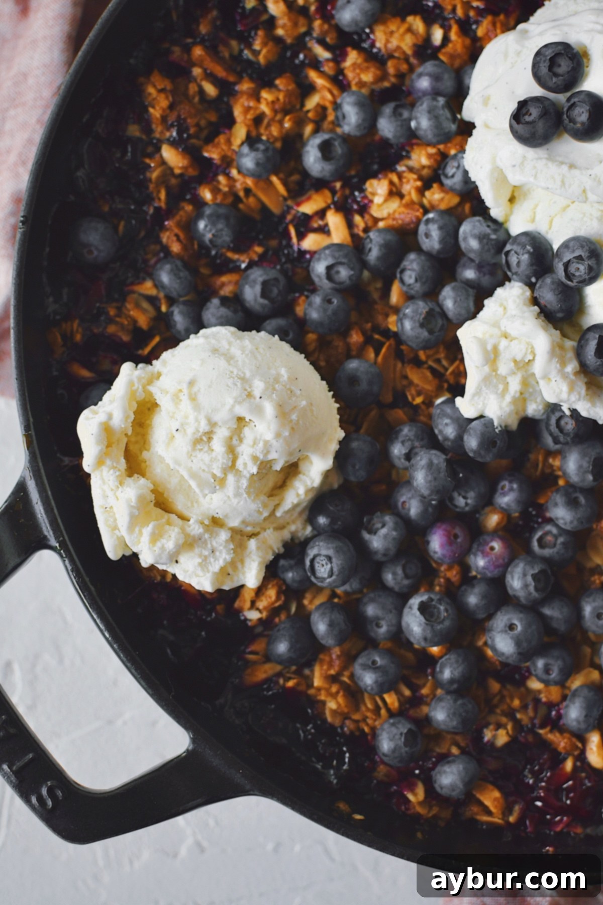 Crisp fresh from the oven with vanilla ice cream on top and extra blueberries.