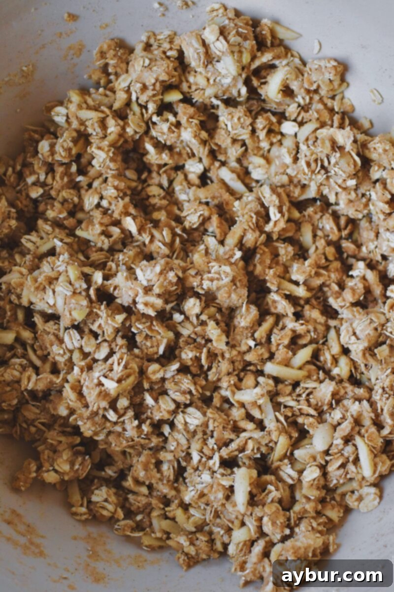 Butter, brown sugar, cinnamon, ginger, salt, and slivered almonds in a large bowl after mixing the crisp topping.