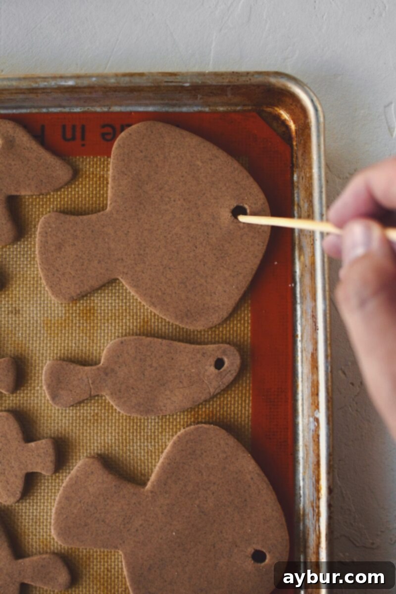 Salt Dough Gingerbread Keepsakes 11 Making a hole in the cut out dough so it can be strung as ornaments after baking and decorating.