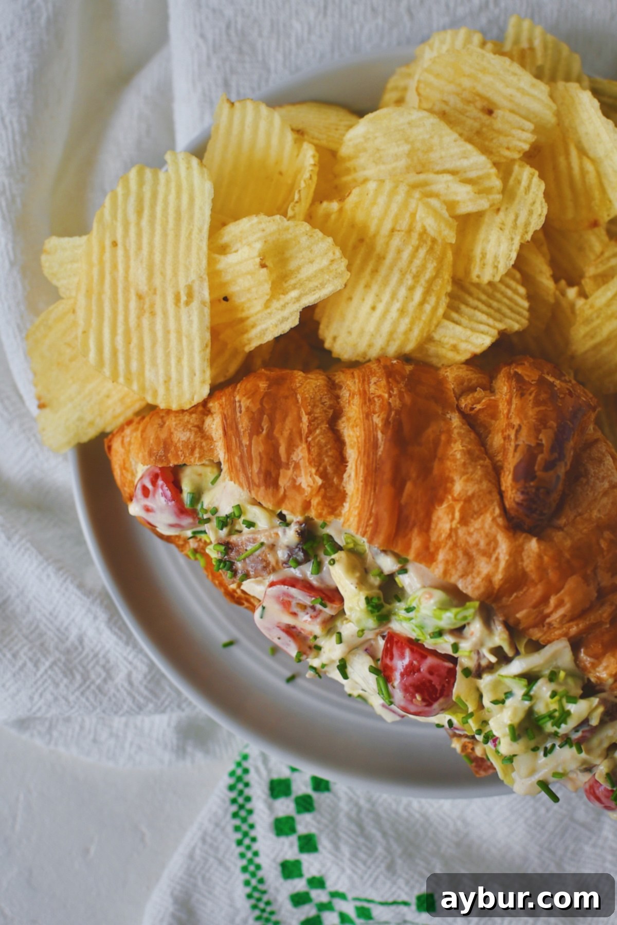 Looking down at a BLT Chicken Salad on a croissant.