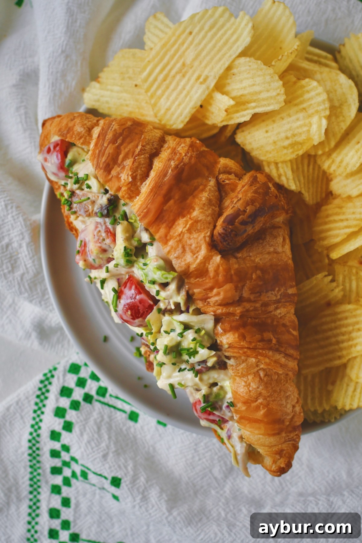 Looking at a BLT Chicken Salad served on a Croissant.