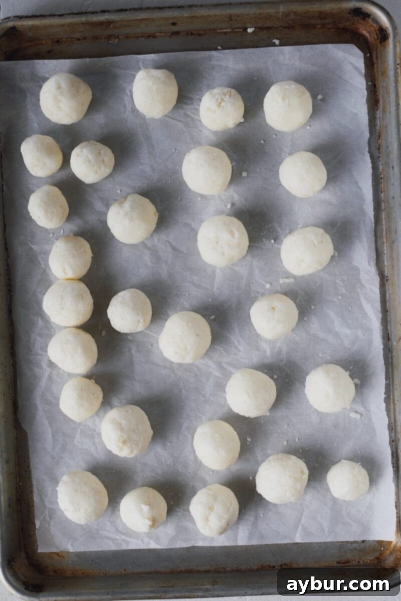 Rolling the portions to to smooth them out.