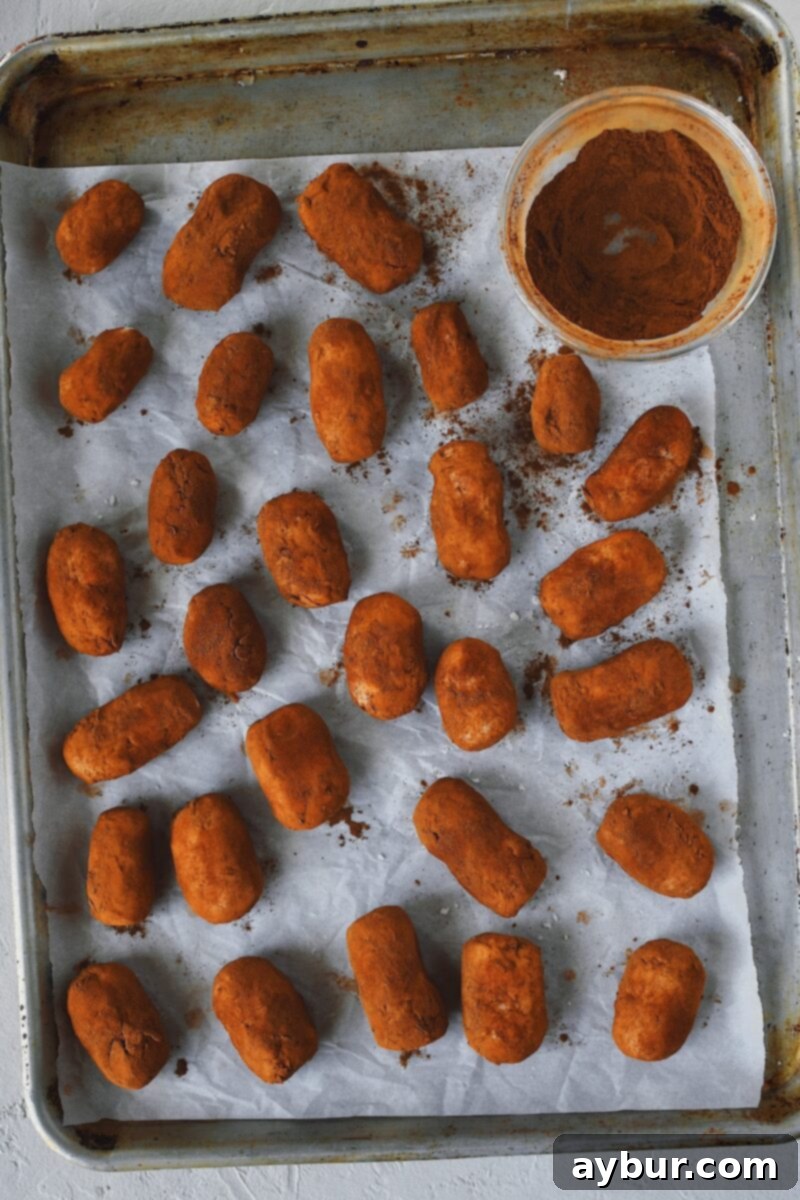 Dusting the "potatoes" in cinnamon to make them look like real potatoes.